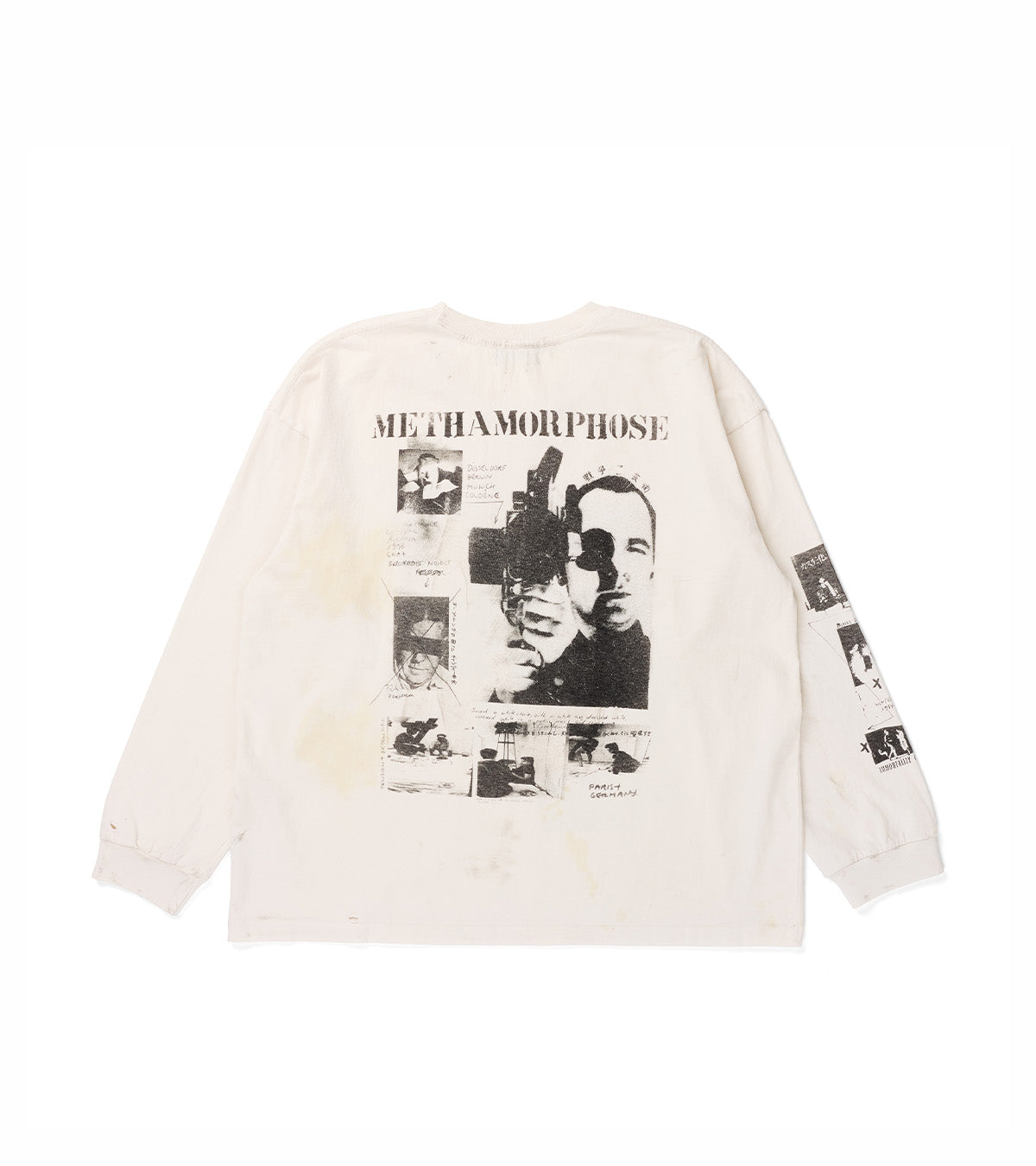 An off-white long-sleeve graphic t-shirt shown from the back, featuring a large black and white print of John Wayne Gacy with the word 'METHAMORPHOSE' and smaller collage images on the back, and additional small prints on the sleeves.